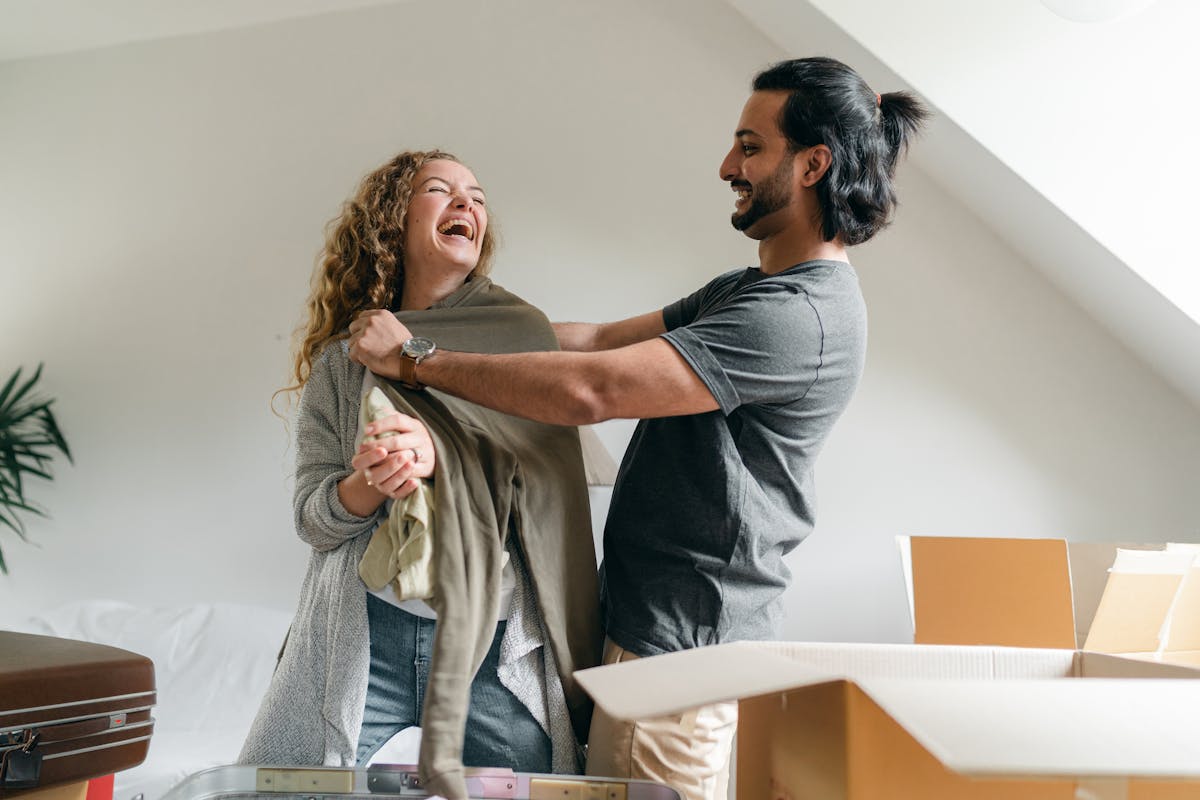 Young couple unpacking boxes in their new home